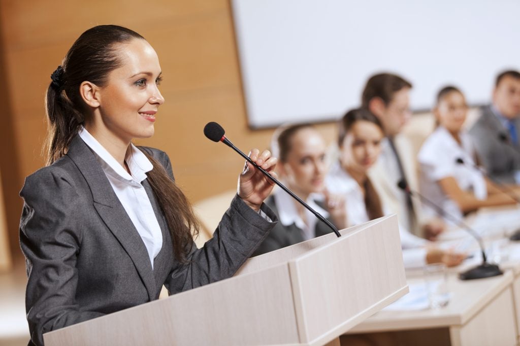 Woman at a podium during a debate